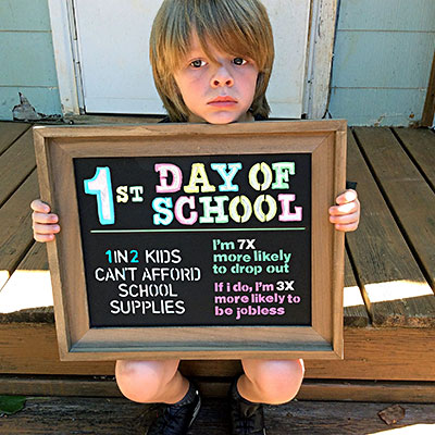 kid holding sign